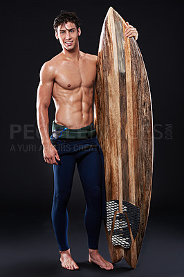 Buy stock photo Full length studio shot of a young surfer with a vintage board