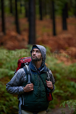 Buy stock photo Portrait of a young man wearing a backpack while hiking in the forest