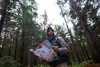 Buy stock photo Lost, man and search forest with map as guide to camp in woods and thinking of navigation or direction. Confused, travel and trekking in nature with backpack and plan to location on hiking journey