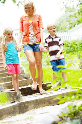 Buy stock photo Two cute young children spending time outdoors with their mother