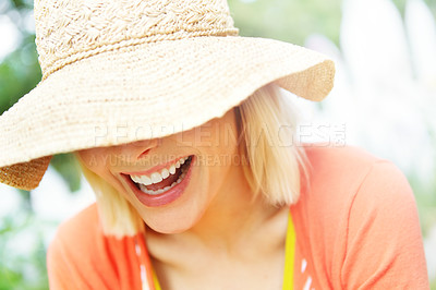 Buy stock photo Face, funny and hat with woman on garden chair in summer for holiday, relax or vacation closeup. Cover, fashion and wellness with happy anonymous person laughing in backyard for peace or quiet