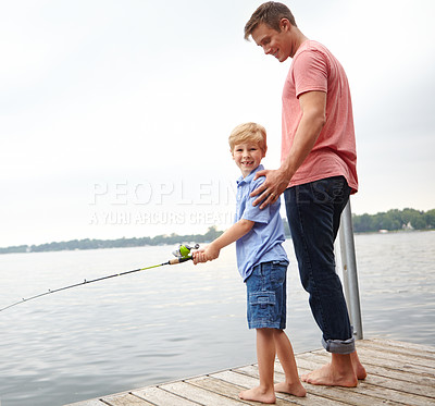 Buy stock photo A father teaching his son how to fish