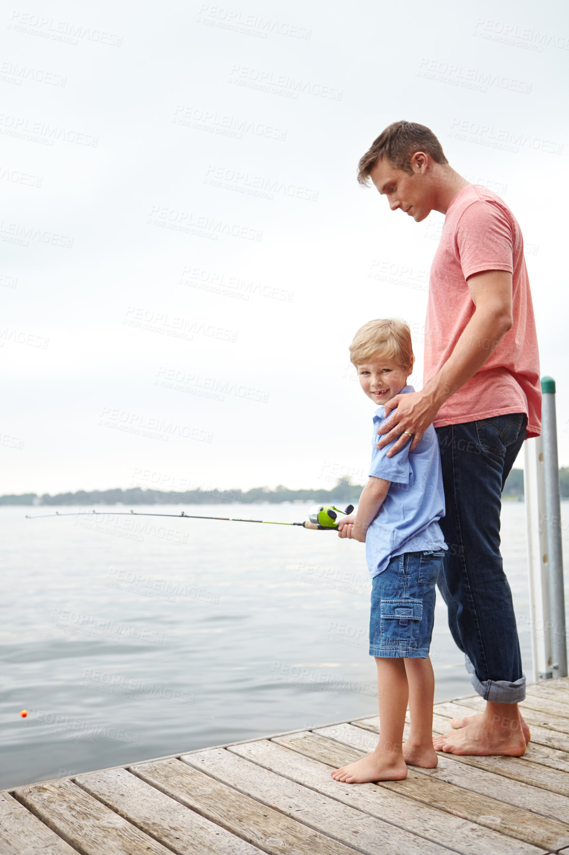 Buy stock photo A father teaching his son how to fish