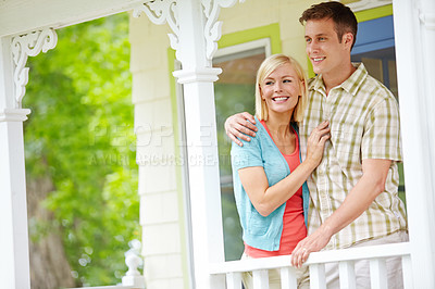 Buy stock photo A happy young couple sharing some quality time together on the porch