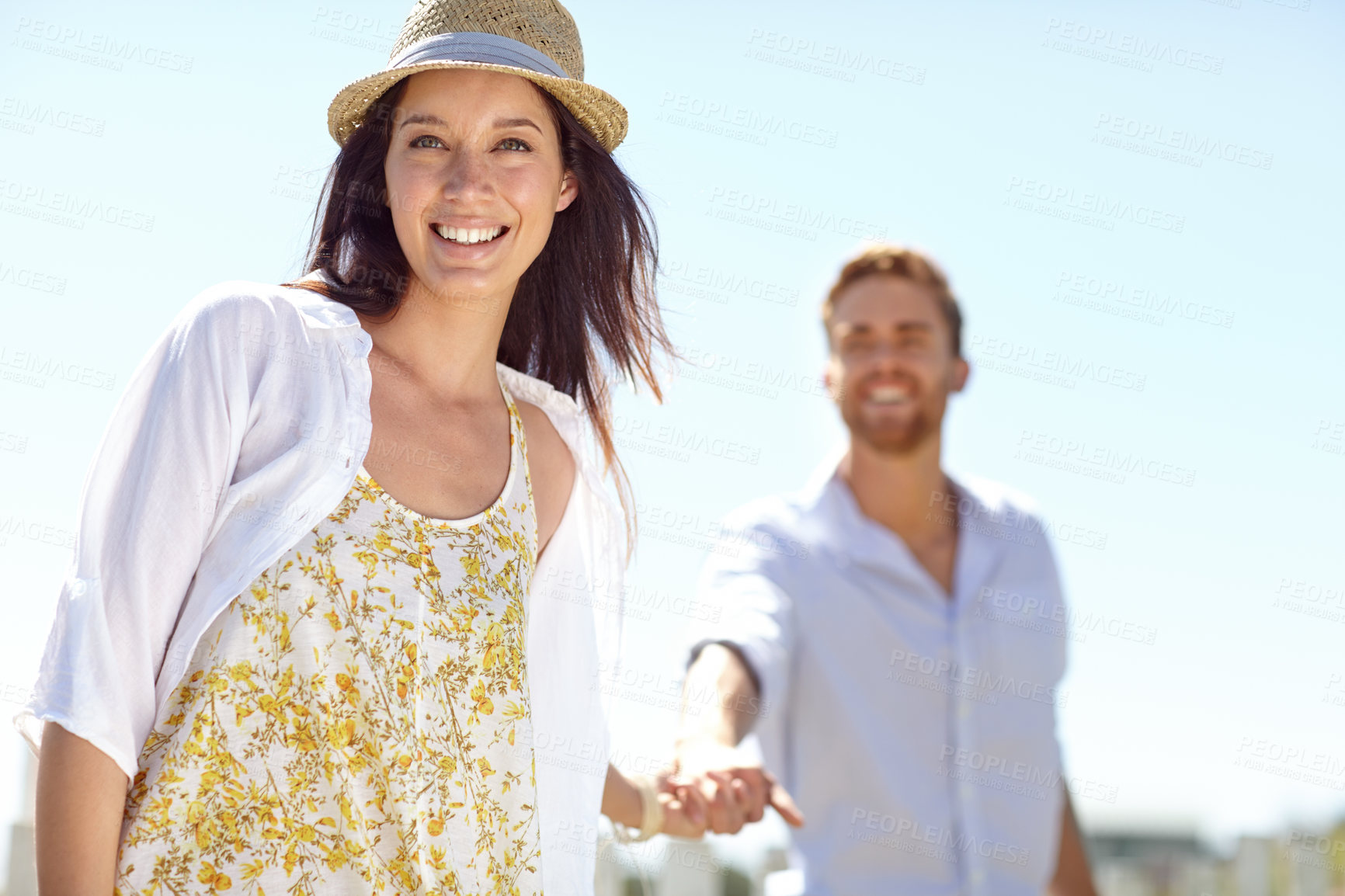 Buy stock photo Young couple holding hands with smile for summer vacation, travel or journey together in the outdoors. Portrait of beautiful woman leading her boyfriend by the hand on a sunny day for the holiday