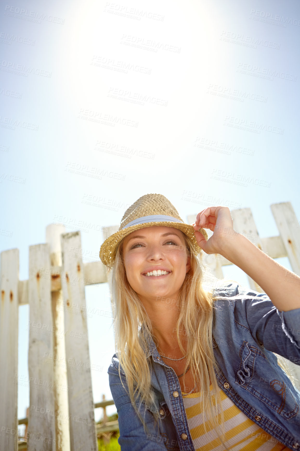 Buy stock photo Woman, hat and blue sky in summer garden, park or mockup lens flare. Sunshine, fashion and female relax at field fence, nature and freedom with happiness in environment for holiday, mock up and smile