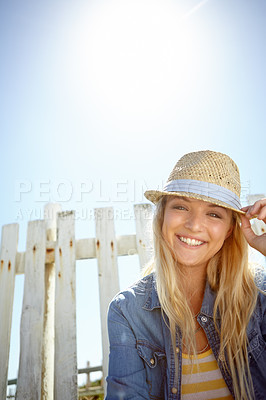 Buy stock photo Woman, hat and portrait in sunshine, blue sky background or mockup lens flare. Summer fashion, park and female relax at field fence, nature and freedom with happiness in environment, mock up or smile
