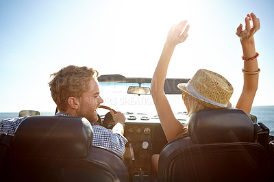 Buy stock photo Car, road trip and freedom with a couple by the beach on a drive to enjoy the view during summer together. Travel, transport and driver with a woman sitting hands raised by the ocean with her man