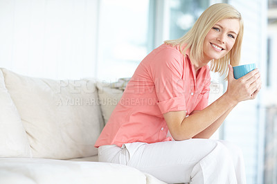 Buy stock photo Shot of a beautiful blonde woman relaxing at home