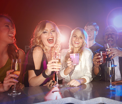 Buy stock photo Friends, drinks and party at a nightclub to celebrate new years, birthday or happy hour while excited, social and happy with alcohol cocktails. Group of men and women with wine glasses for cheers