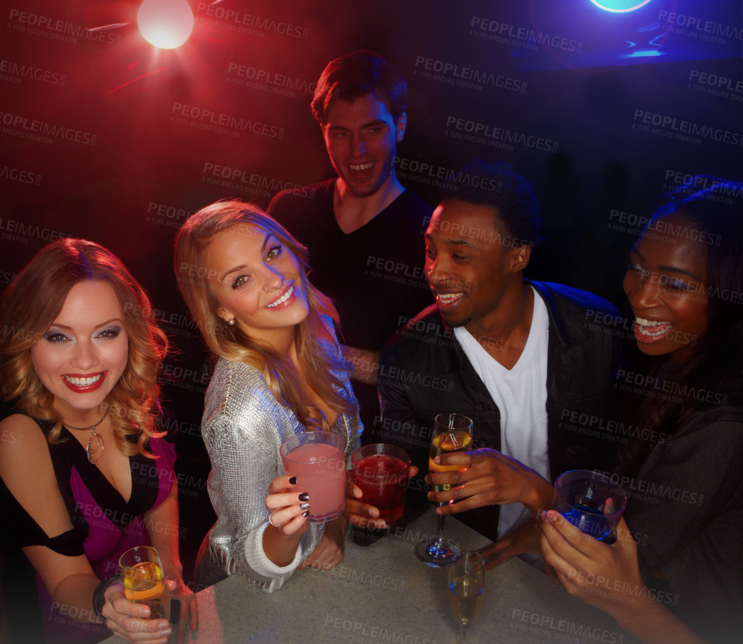 Buy stock photo A group of friends smiling at the camera while they enjoy drinks in a nightclub - high angle