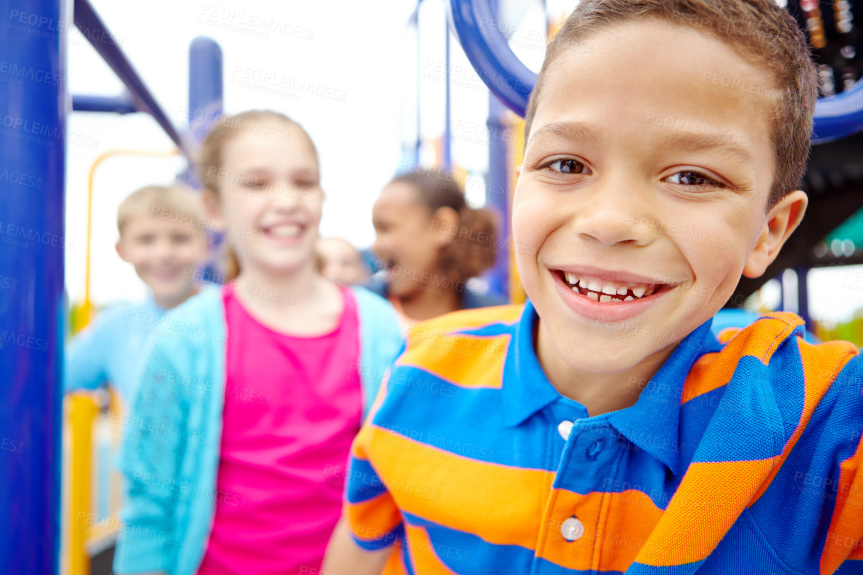 Buy stock photo A multi-ethnic group of happy children playing on a jungle gym in a play park