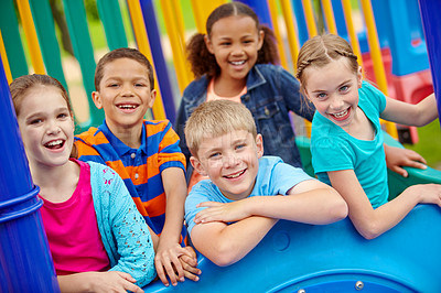 Buy stock photo A multi-ethnic group of happy children playing on a jungle gym in a play park