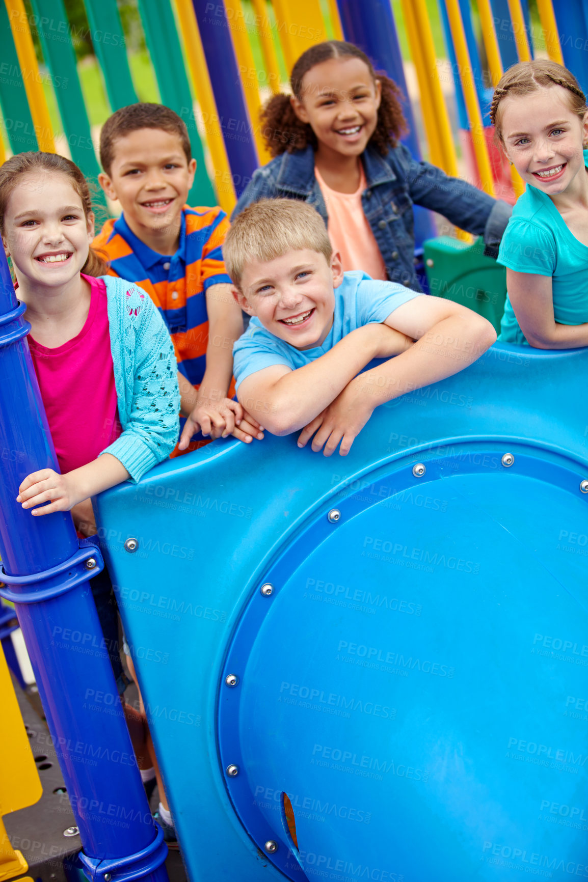 Buy stock photo A multi-ethnic group of happy children playing on a jungle gym in a play park