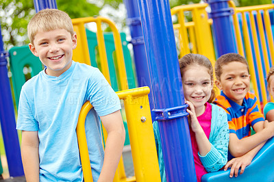 Buy stock photo A multi-ethnic group of happy children playing on a jungle gym in a play park