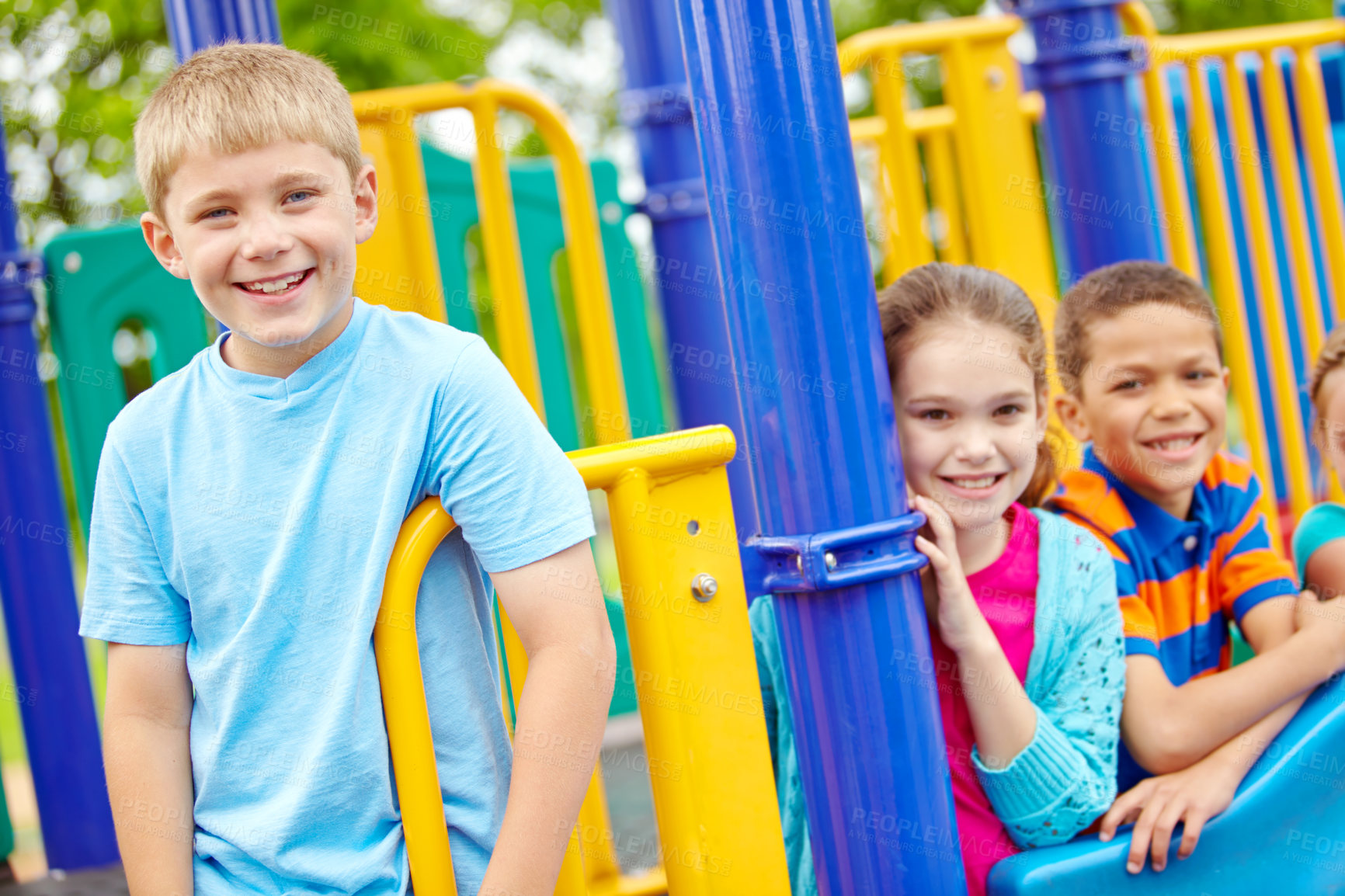 Buy stock photo A multi-ethnic group of happy children playing on a jungle gym in a play park