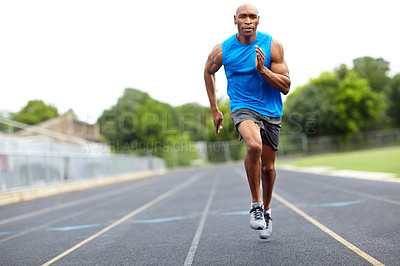 Buy stock photo Full length portrait of a male runner sprinting on the race track