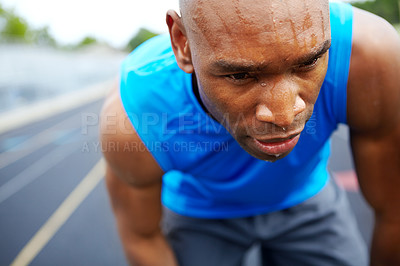 Buy stock photo Cropped close up of a male athlete getting into the starting position