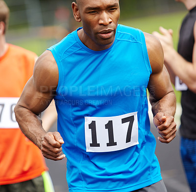 Buy stock photo Cropped front view of a male competitor with his racing number displayed on his sport shirt preparing for the race
