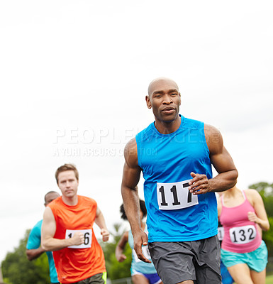 Buy stock photo Cropped front view of a perservering male athlete running in first place