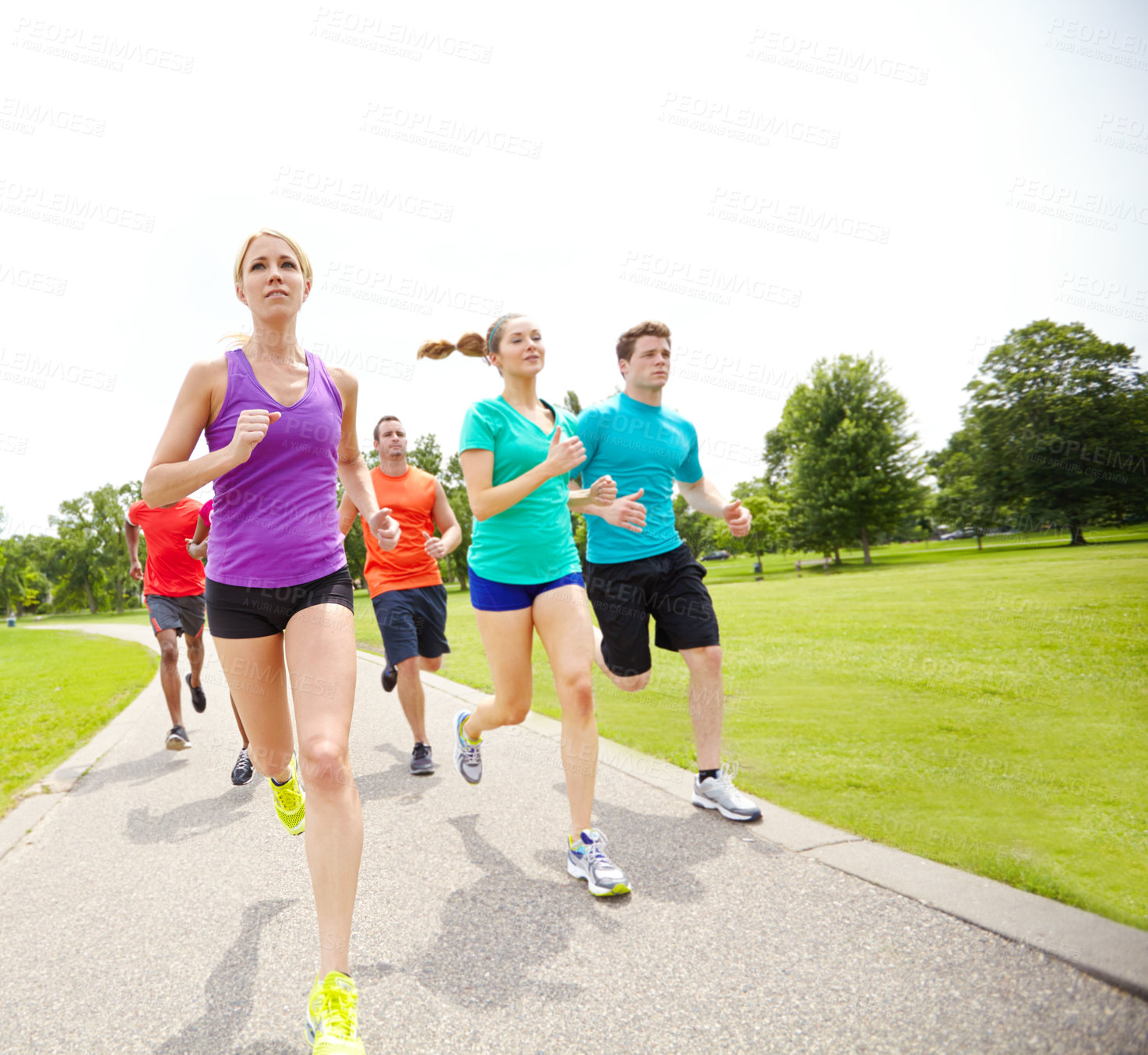 Buy stock photo Front view of a group of male and female athletes running outside