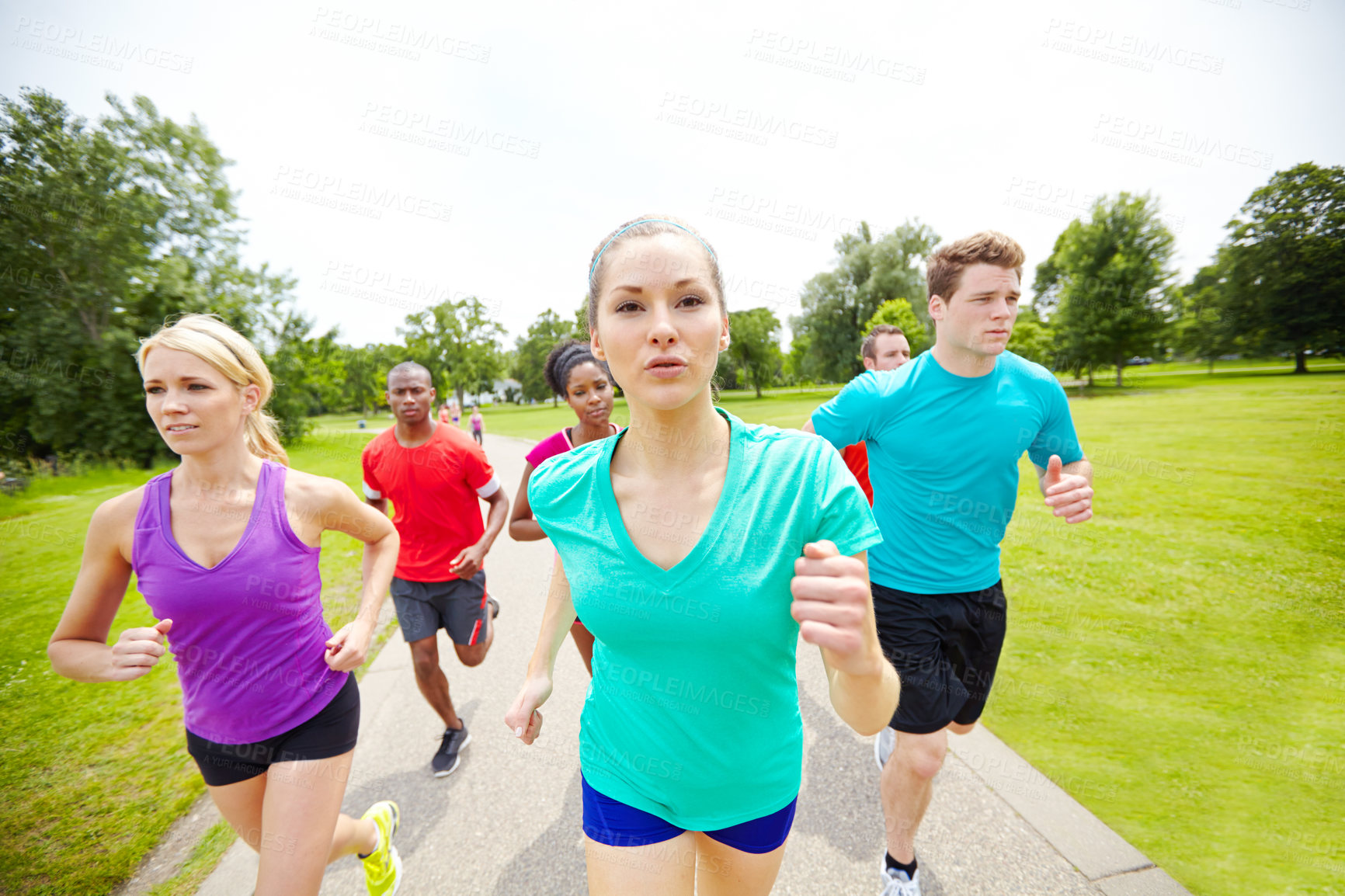 Buy stock photo Cropped front view of a group of athletes running outdoors