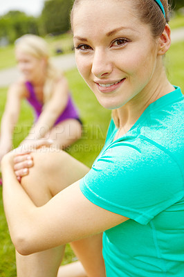Buy stock photo Cropped side view of female athlete stretching outdoors