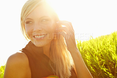 Buy stock photo A beautiful young blonde woman sitting in a field