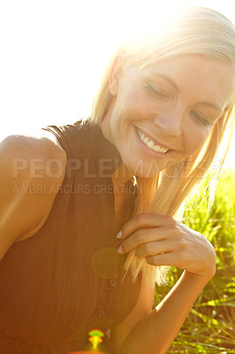 Buy stock photo A beautiful young blonde woman sitting in a field