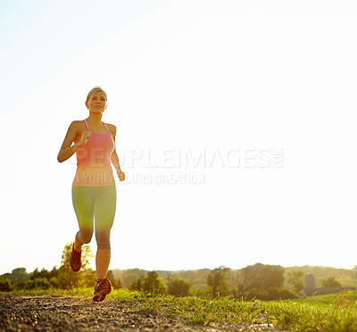 Buy stock photo A young woman running along a dirt road