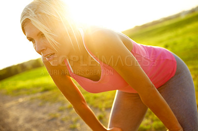Buy stock photo A beautiful young woman in sportswear with hands on her knees