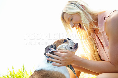 Buy stock photo Companion, cuddle or petting with woman and dog outdoor in park together for bonding, training or walk. Smile, vitality or wellness with bulldog and owner in nature for summer activity or exercise