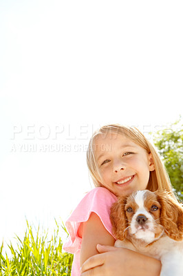 Buy stock photo Portrait of a cute little girl hugging her puppy while enjoying a day out