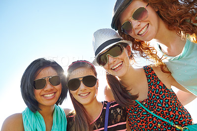 Buy stock photo A group of four teenage girls smiling with their arms around each other's shoulders