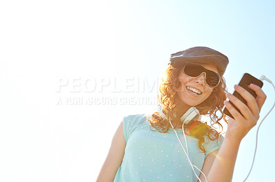 Buy stock photo Woman, outdoor and phone for playlist on headphones, website and search online for music sound. Female person, communication and blue sky mockup space in nature, social media surfing and audio song