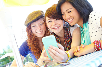 Buy stock photo Friends, cafe and smartphone with laugh, comic meme and reading together on social media app. Happy teens, phone and group of girls with funny video, joke or web blog for outdoor summer travel