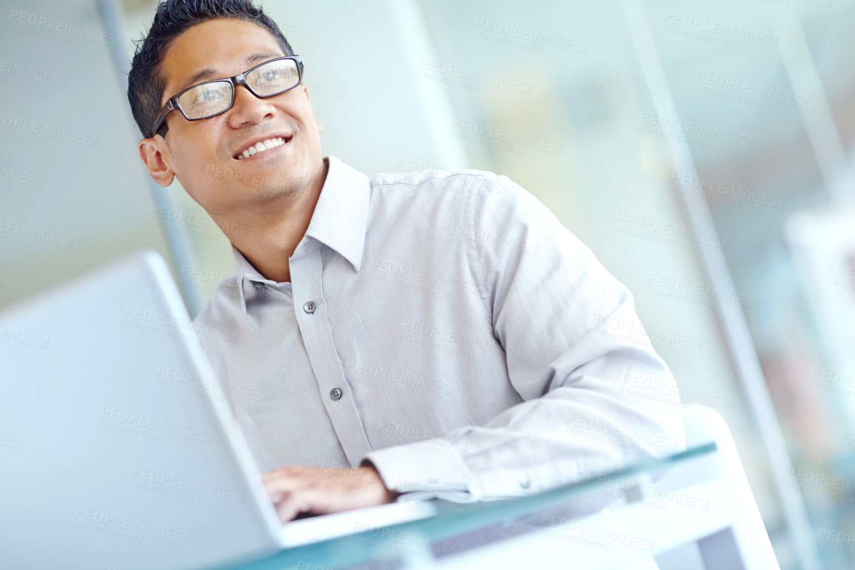 Buy stock photo Thoughtful young asian businessman working on his laptop 