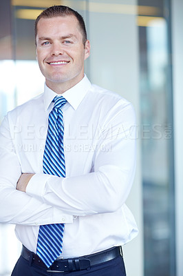 Buy stock photo Smiling caucasian businessman standing at work with his arms folded