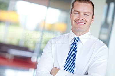 Buy stock photo Smiling caucasian businessman standing at work with his arms folded