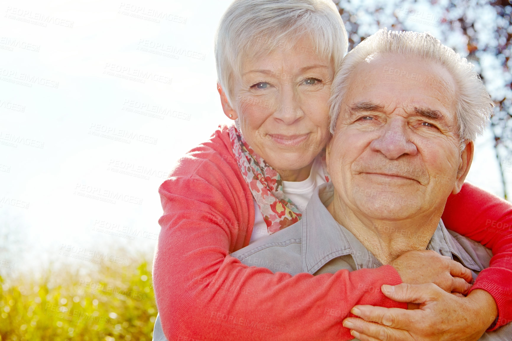 Buy stock photo Portrait shot of a mature woman embracing her husband