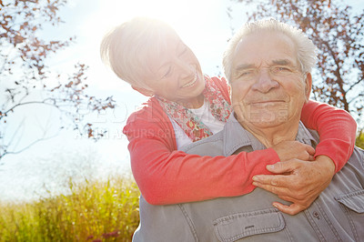 Buy stock photo Hug, date and love with old couple in park for retirement, romance and bonding. Support, marriage milestone and spring with senior man and woman relax in nature for wellness with care and smile