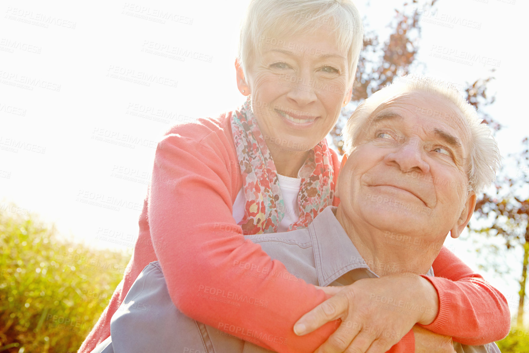 Buy stock photo Image of a mature woman embracing her husband outdoors in nature