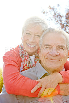 Buy stock photo Hug, portrait and support with old couple in park for retirement, romance and date. Love, marriage milestone and spring with senior man and woman walking in nature for wellness, care and smile