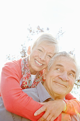 Buy stock photo Close up shot of an elderly woman hugging her husband