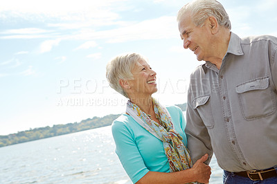 Buy stock photo Smile, senior couple and blue sky on lake for support, retirement vacation and travel destination. Below, people and mockup space with affection, partner love and marriage commitment for pier holiday