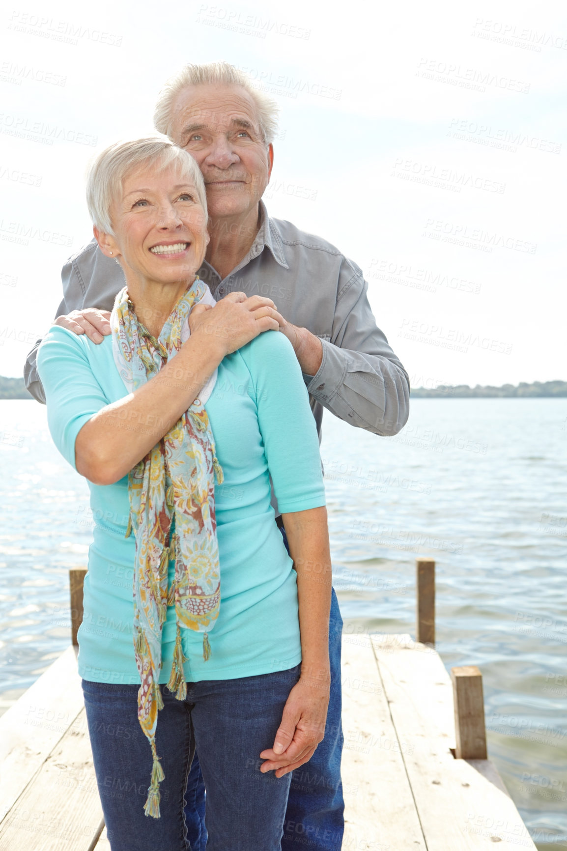 Buy stock photo Love, travel and senior couple at lake for loyalty, strong relationship and connection on holiday. Vacation, happy man and woman by water pier outdoor for support, view and marriage in retirement