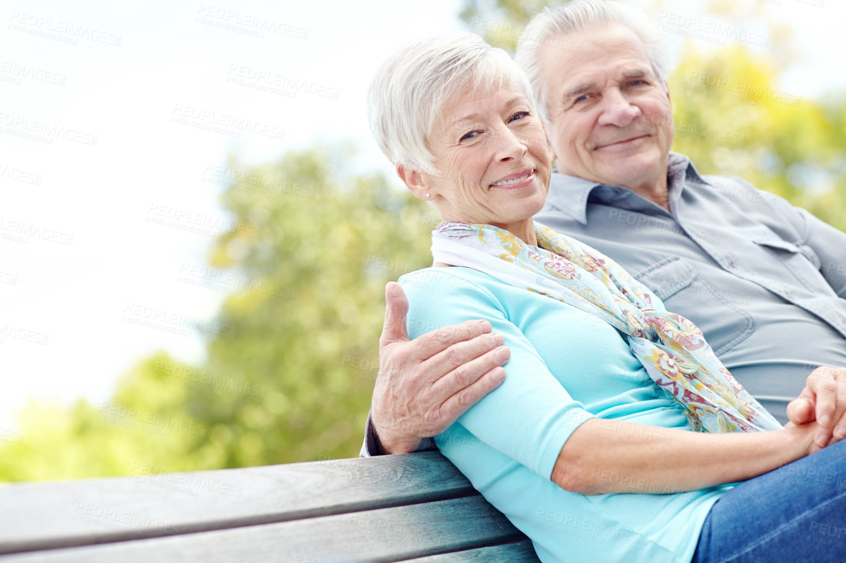 Buy stock photo A senior couple sitting together on a bench