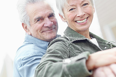 Buy stock photo Cropped image of a mature husband and wife sitting together on a bench