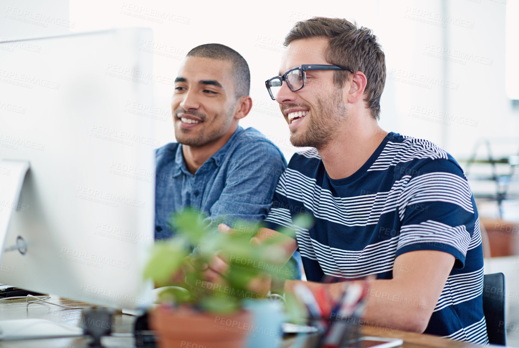 Buy stock photo Shot of two colleagues working together at a computer