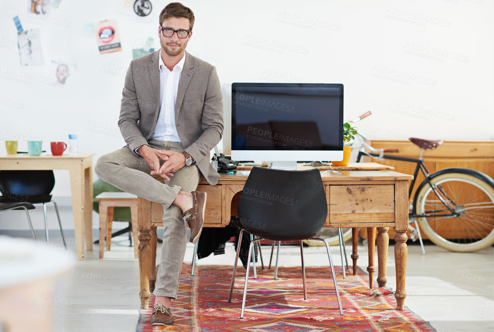 Buy stock photo Graphic designer, man and portrait in workplace by computer with pride, suit or mockup space on screen. Person, glasses and sitting by desktop pc at startup for creativity in career at small business